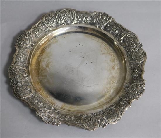 A Spanish silver plate with shell and rose border,
